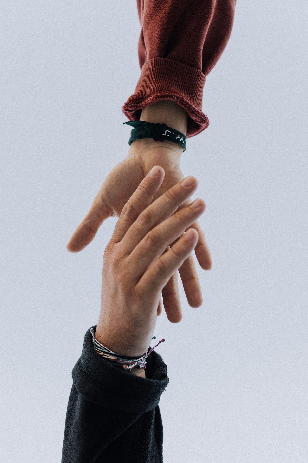 view of two persons hands